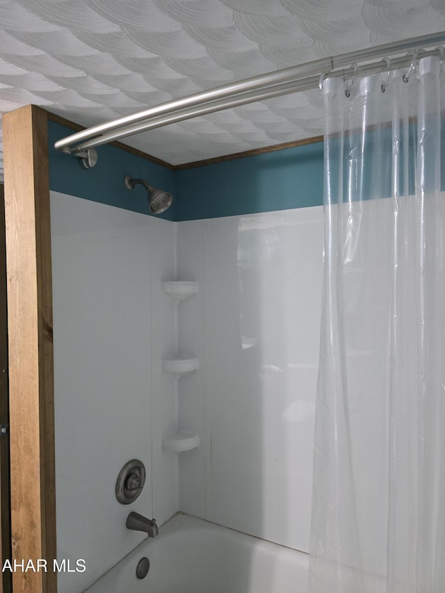 bathroom featuring shower / tub combo with curtain