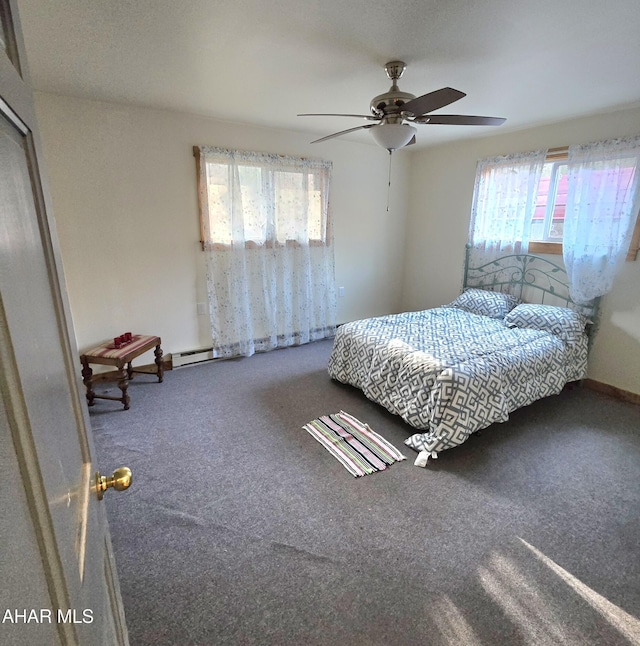 bedroom with carpet floors, ceiling fan, and a baseboard heating unit