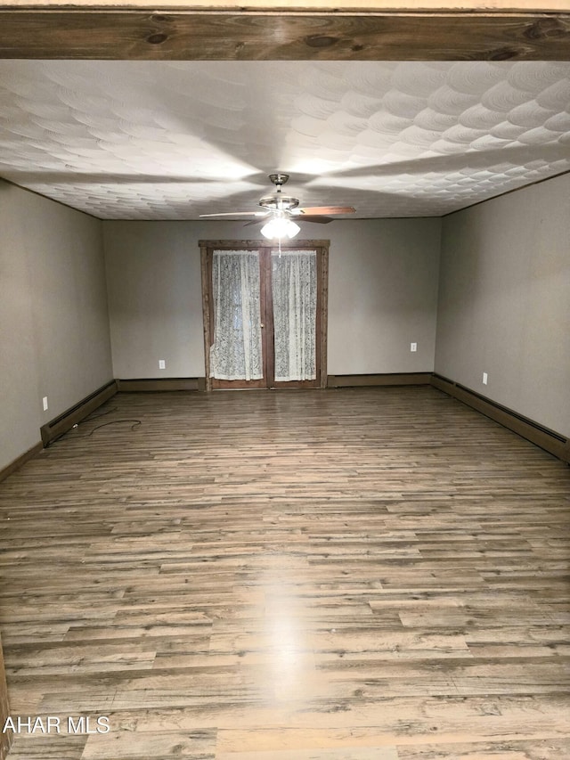 spare room with light hardwood / wood-style floors and a baseboard heating unit