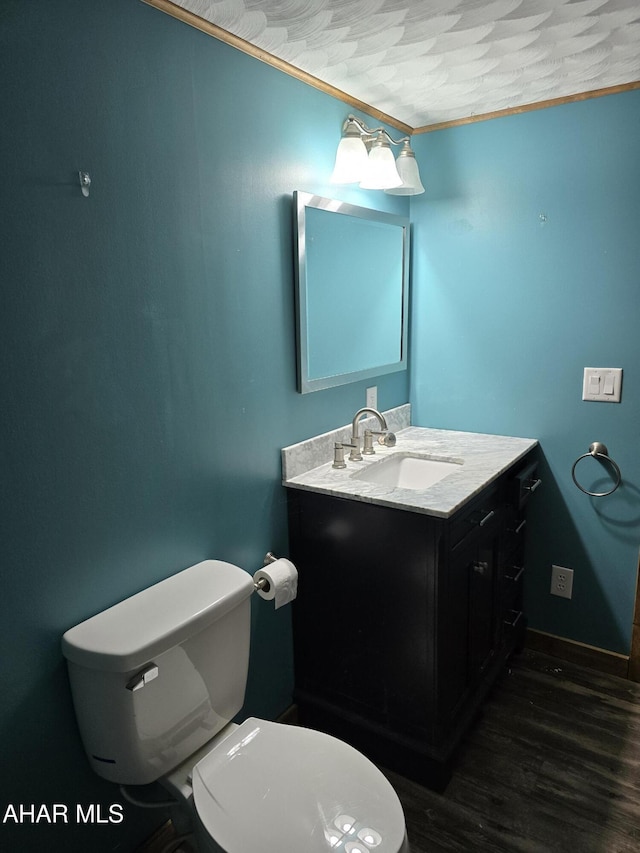 bathroom with hardwood / wood-style floors, vanity, and toilet