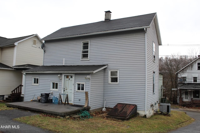 rear view of property with cooling unit