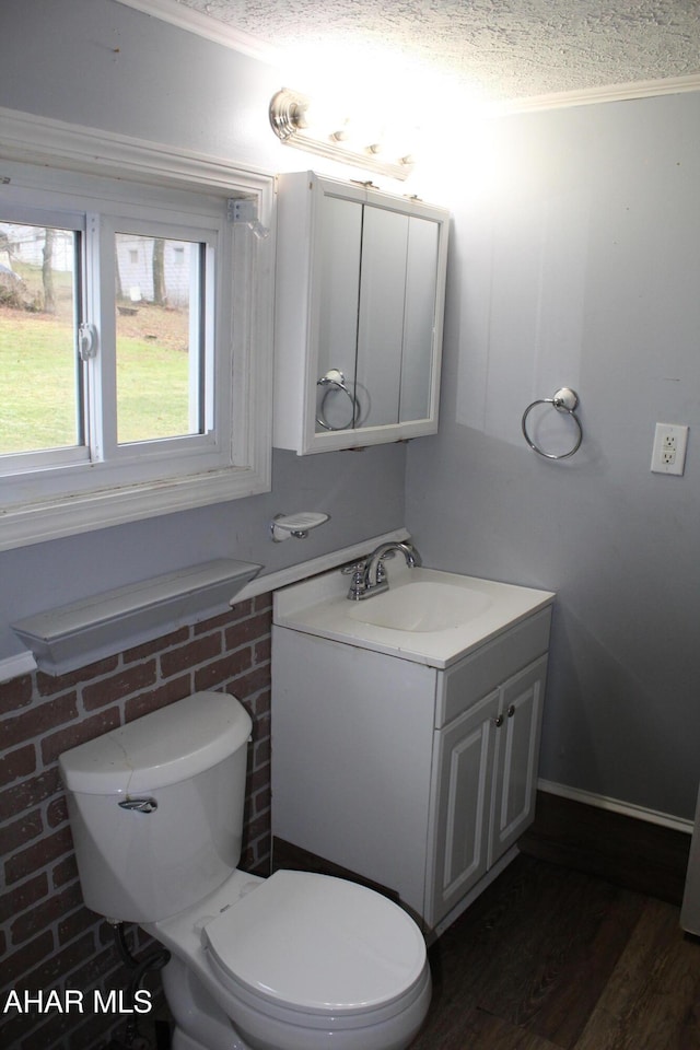 bathroom with hardwood / wood-style flooring, vanity, a textured ceiling, and toilet