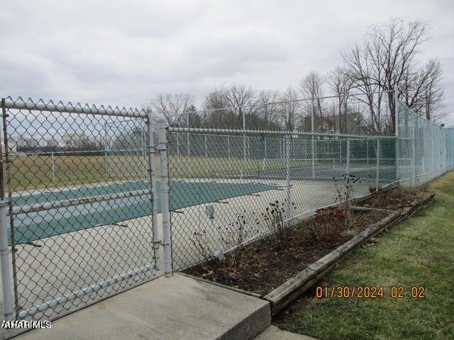 view of pool with tennis court