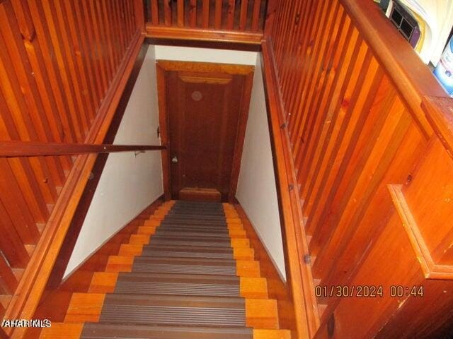 staircase with hardwood / wood-style flooring