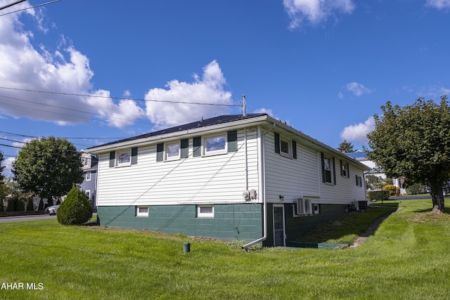 view of side of property with a lawn and central AC unit