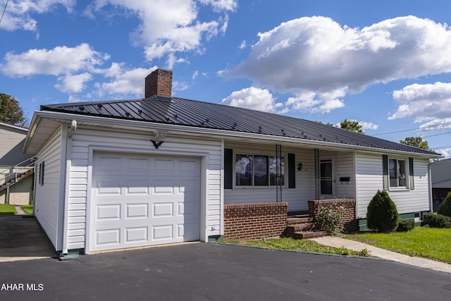 single story home with a porch and a garage