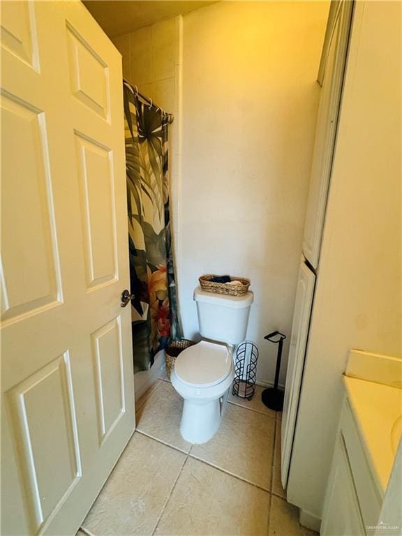 bathroom featuring toilet, vanity, and tile patterned floors