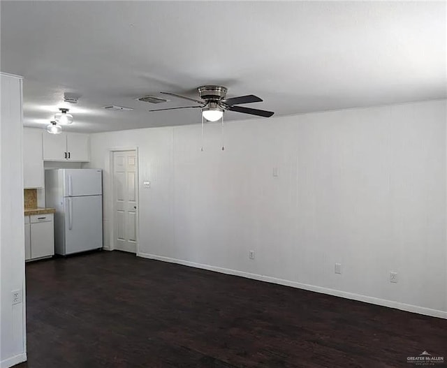 empty room with dark hardwood / wood-style floors and ceiling fan