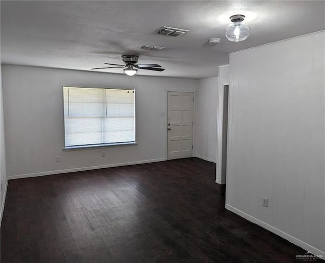 spare room with ceiling fan and dark wood-type flooring