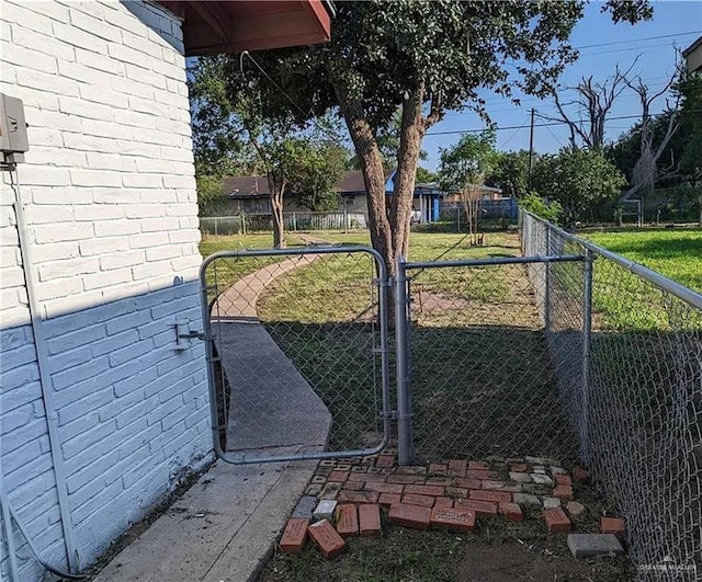 view of gate featuring a lawn