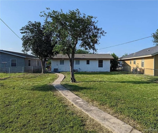 rear view of property with a lawn