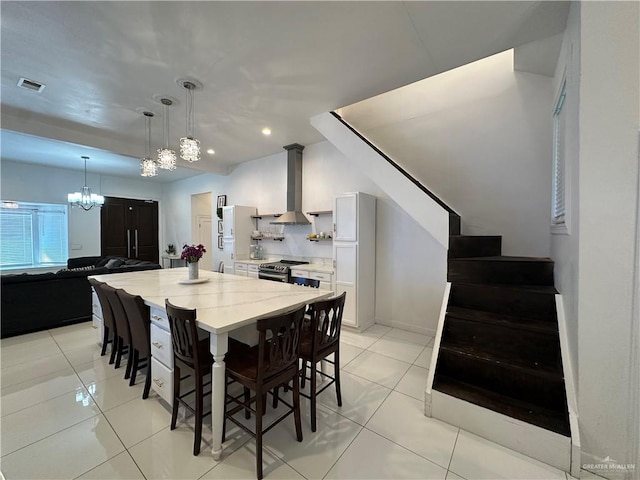 dining room featuring light tile patterned flooring and a chandelier