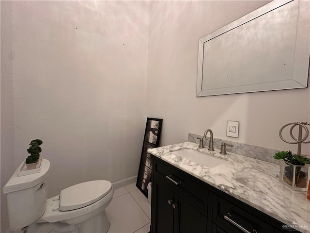 bathroom featuring toilet, vanity, and tile patterned floors