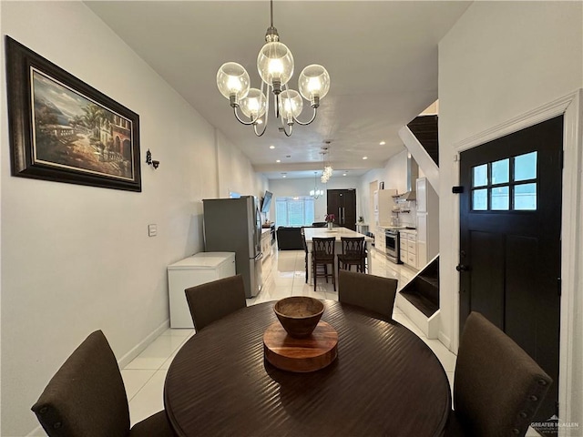 dining area featuring light tile patterned floors and an inviting chandelier