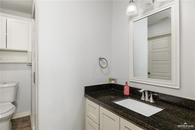 bathroom with toilet and vanity