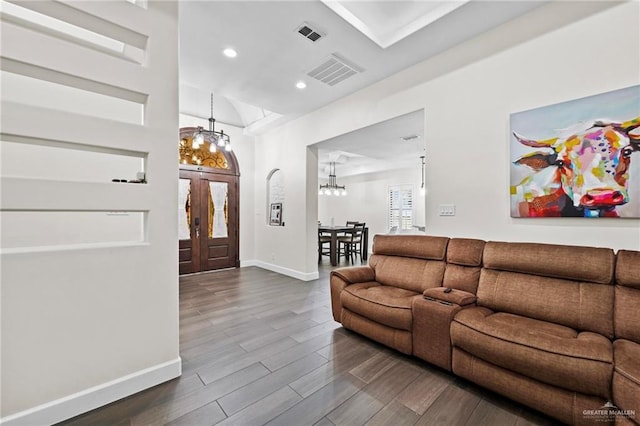 living room with wood-type flooring and an inviting chandelier