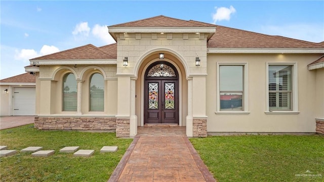 doorway to property featuring a lawn