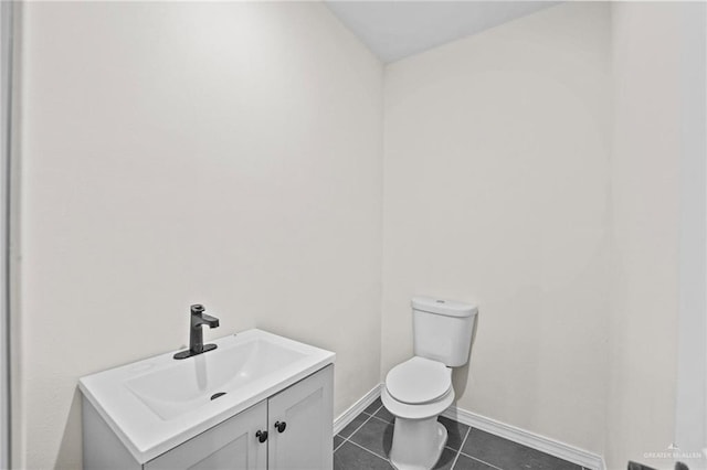 bathroom with tile patterned flooring, vanity, and toilet