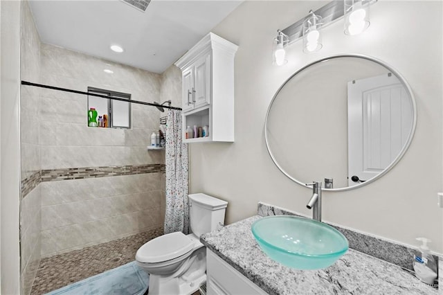 bathroom with vanity, toilet, and walk in shower