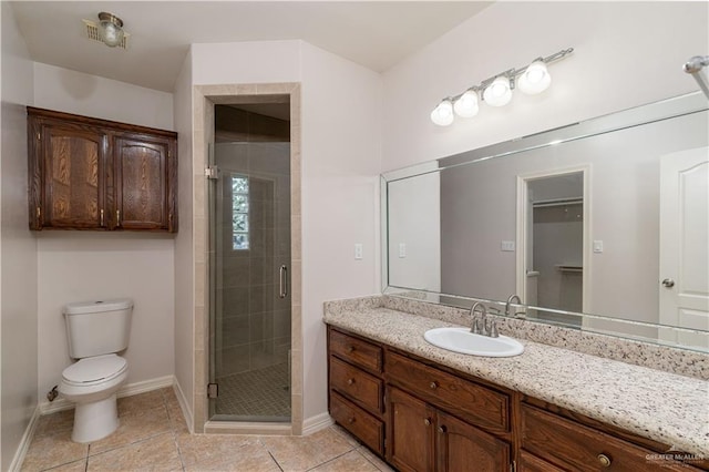 1711 Esperanza Ave, Hidalgo, TX 78557 - bathroom featuring toilet, a stall shower, vanity, tile patterned floors, and baseboards