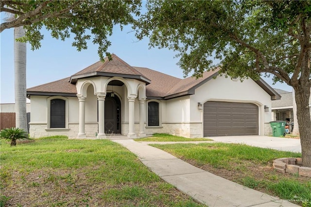 1711 Esperanza Ave, Hidalgo, TX 78557 - view of front of house with stucco siding, an attached garage, a shingled roof, and a front yard