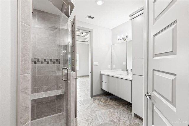 bathroom featuring vanity and an enclosed shower