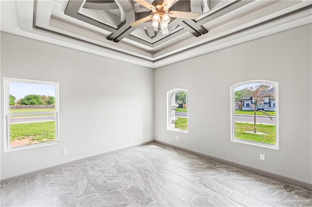 unfurnished room featuring ceiling fan, a healthy amount of sunlight, and coffered ceiling