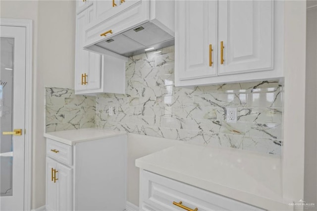 3003 E Palo Blanco St, Hidalgo, TX 78557 - kitchen featuring premium range hood, light countertops, backsplash, and white cabinetry