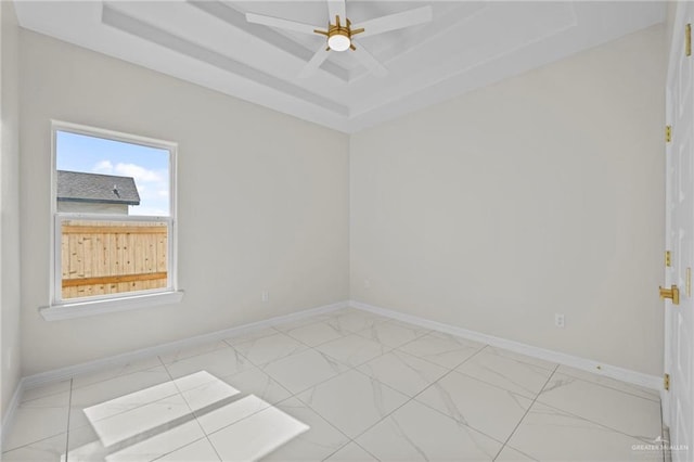 3003 E Palo Blanco St, Hidalgo, TX 78557 - unfurnished room featuring light marble finish flooring, a tray ceiling, and baseboards