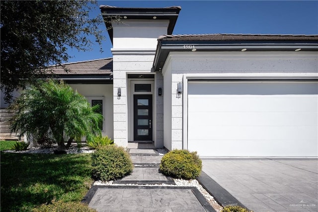 view of front of home with an attached garage, driveway, and a tiled roof