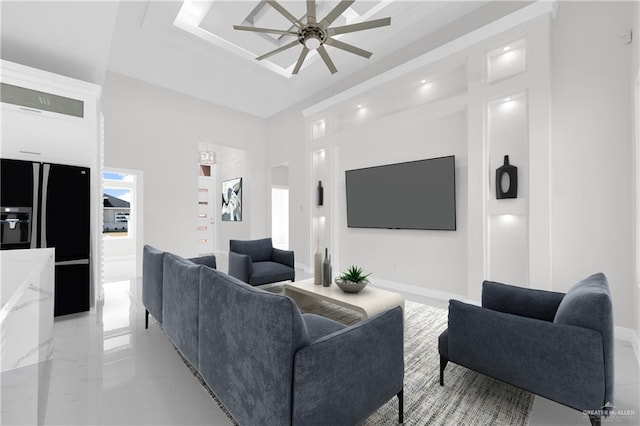 unfurnished living room featuring a high ceiling, sink, and ceiling fan