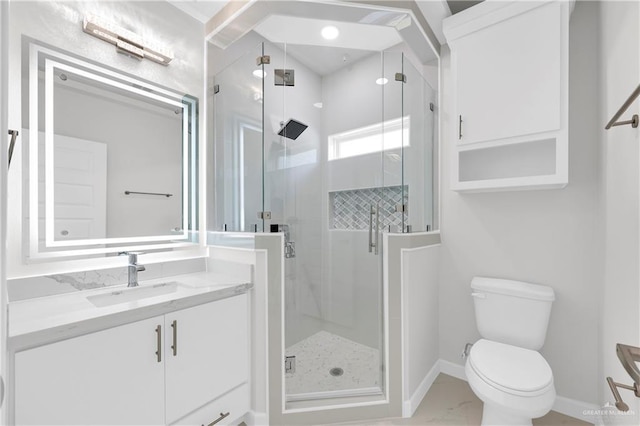 bathroom with vanity, a shower with shower door, and toilet