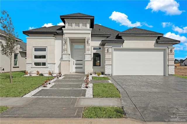 prairie-style home featuring a garage and a front yard