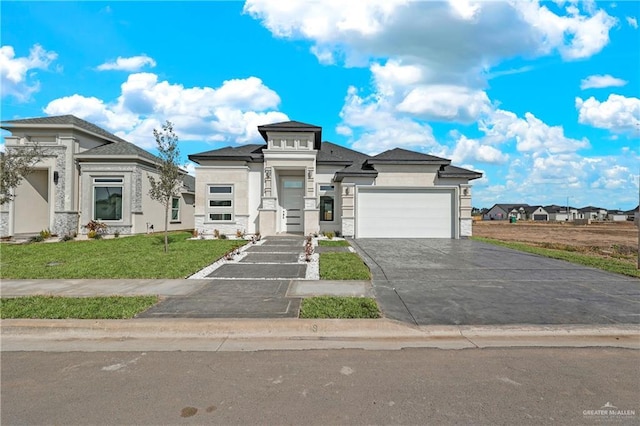 view of front of home featuring a garage and a front yard