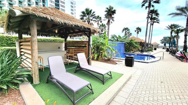 310A Padre Blvd, South Padre Island, TX 78597 - view of patio with a bar, a community pool, and a gazebo