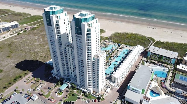 bird's eye view with a water view and a beach view