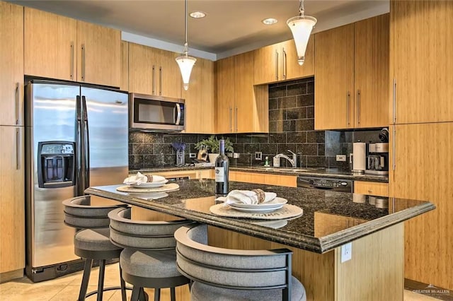 310A Padre Blvd, South Padre Island, TX 78597 - kitchen with dark stone counters, backsplash, pendant lighting, and stainless steel appliances