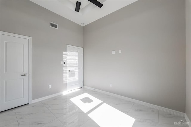 spare room with ceiling fan and a towering ceiling