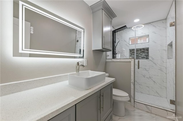 bathroom with vanity, toilet, and a shower with shower door