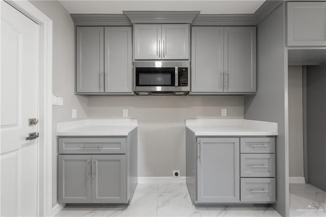 kitchen with gray cabinets and light stone countertops