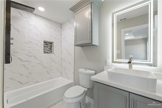 full bathroom with vanity, toilet, and tiled shower / bath combo