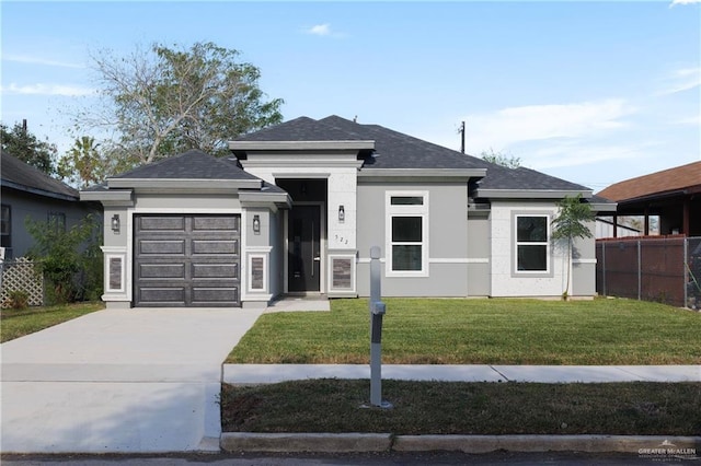 prairie-style house featuring a garage and a front yard