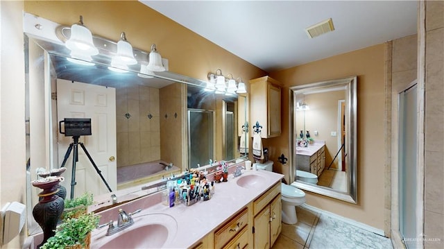 bathroom with toilet, a stall shower, a sink, and visible vents