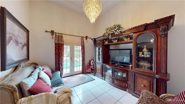 living area with a notable chandelier, french doors, and light tile patterned flooring