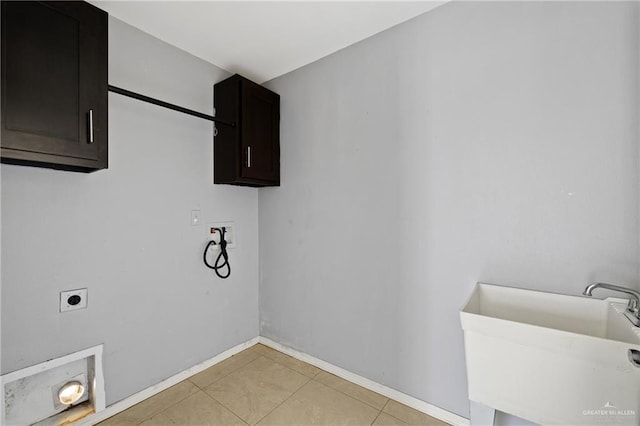 laundry area with sink, cabinets, washer hookup, light tile patterned floors, and electric dryer hookup