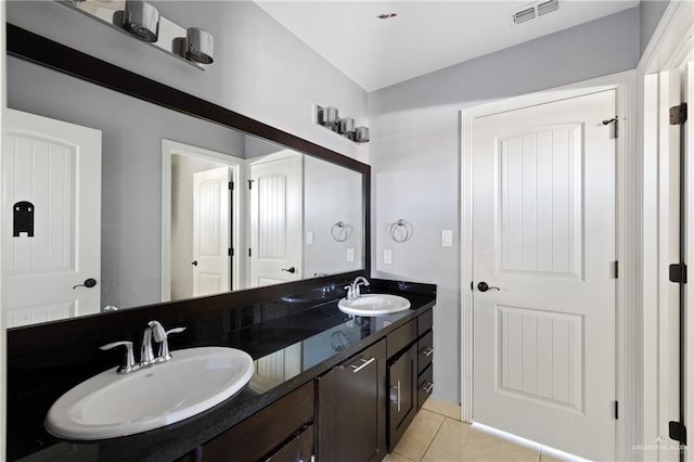 bathroom with tile patterned flooring and vanity