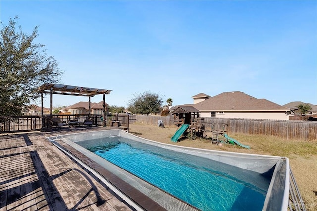 view of swimming pool featuring a pergola and a playground