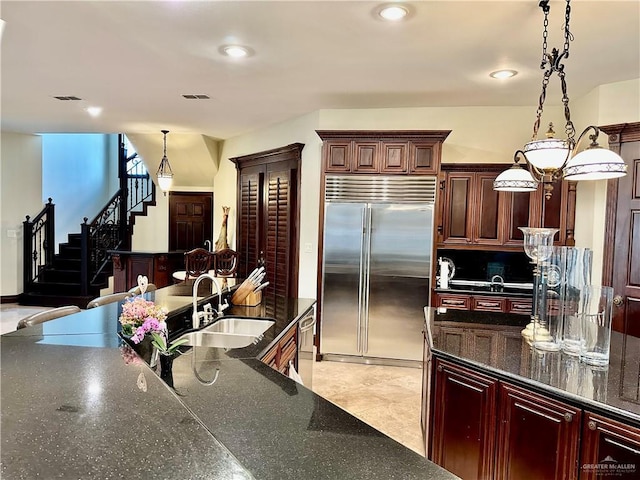 kitchen featuring appliances with stainless steel finishes, sink, pendant lighting, and backsplash