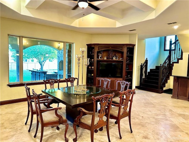 dining space featuring coffered ceiling, a raised ceiling, and ceiling fan