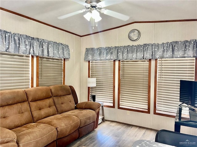 living room featuring ceiling fan, ornamental molding, and light hardwood / wood-style flooring